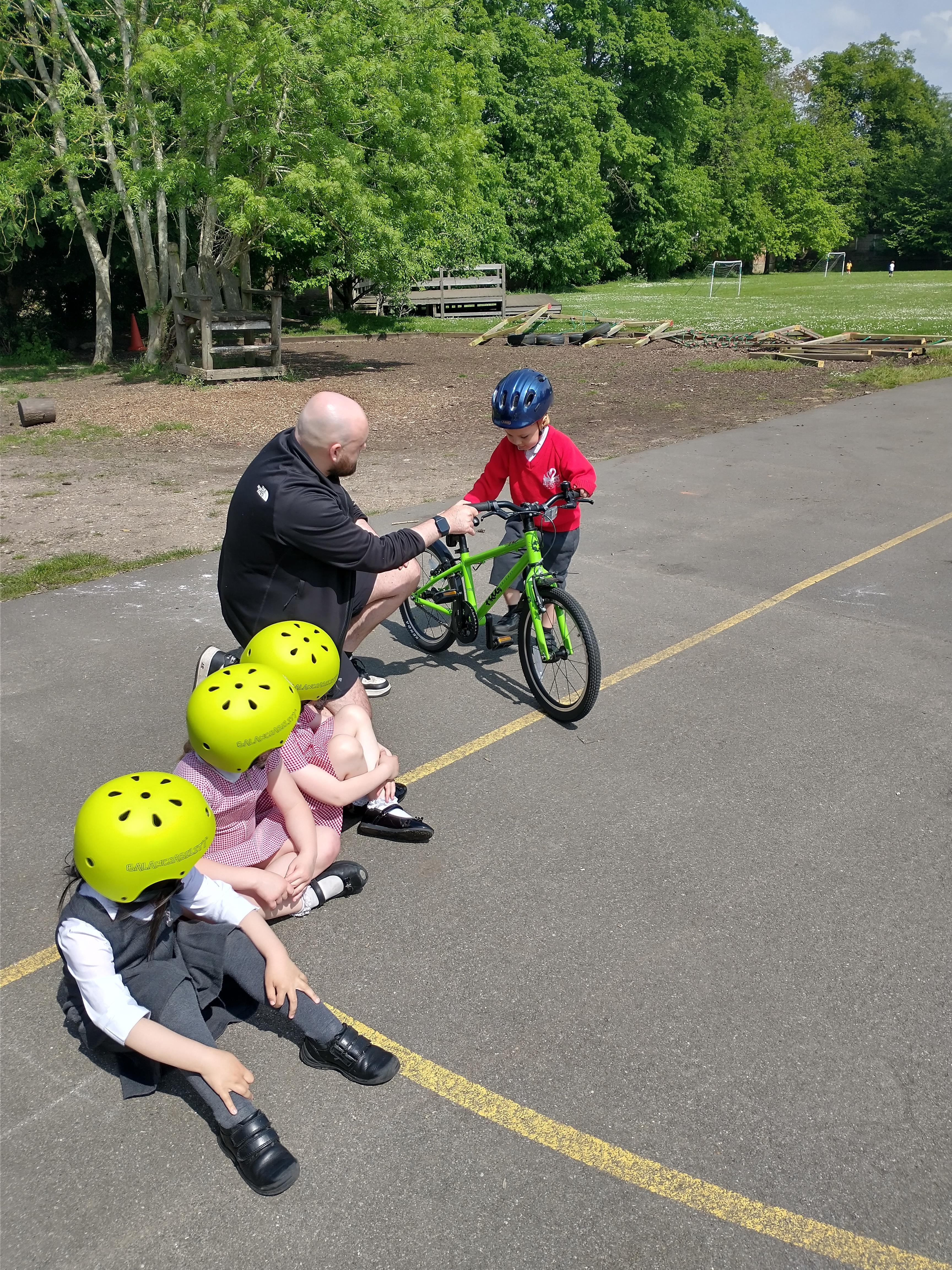 Foundation children learning how to ride a bike in their bikeability lessons.